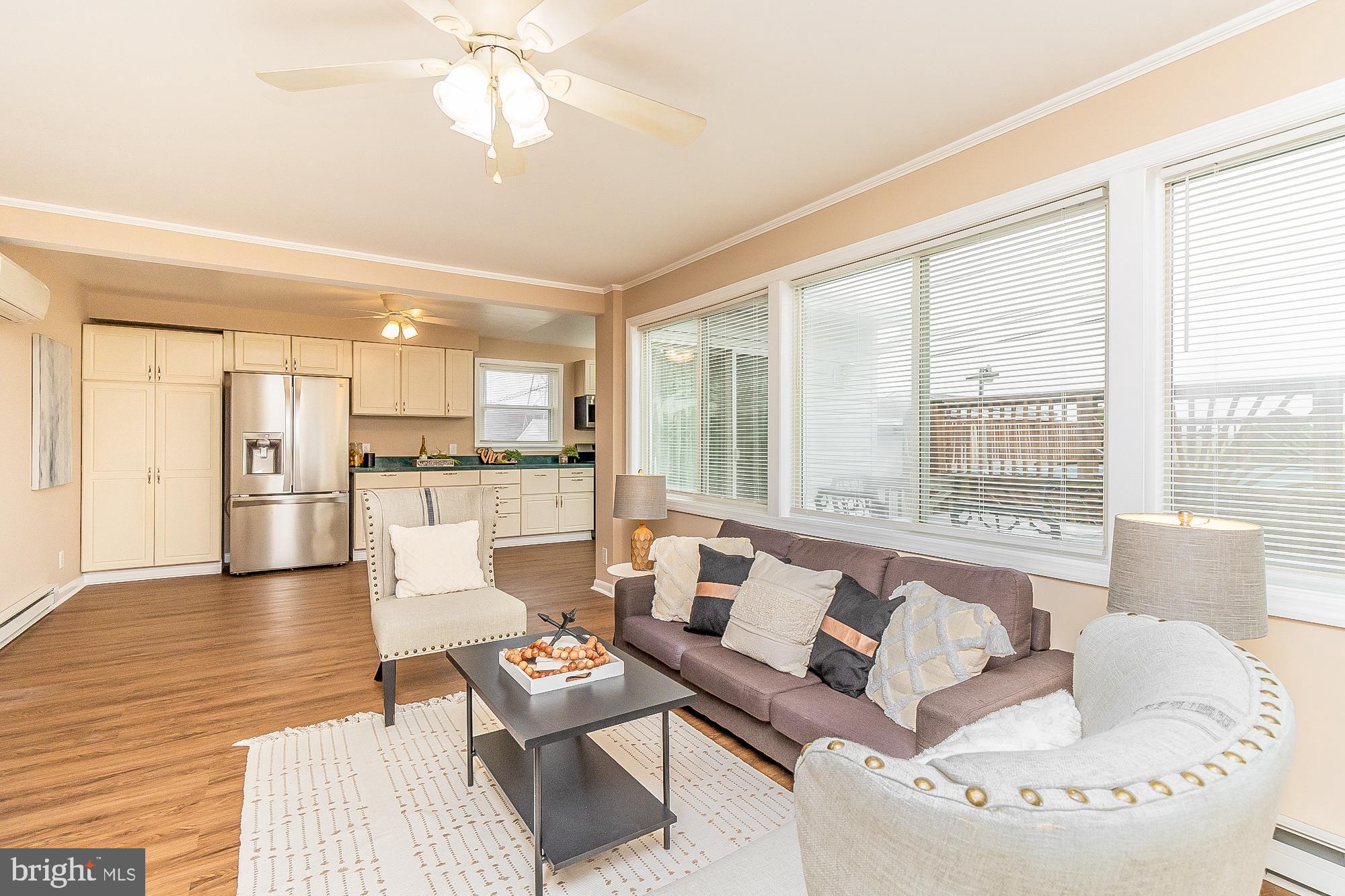 7501 Kenlea Avenue Nottingham, MD 21236 - Photo 16 of 55 a living room with furniture and a large window with kitchen view
