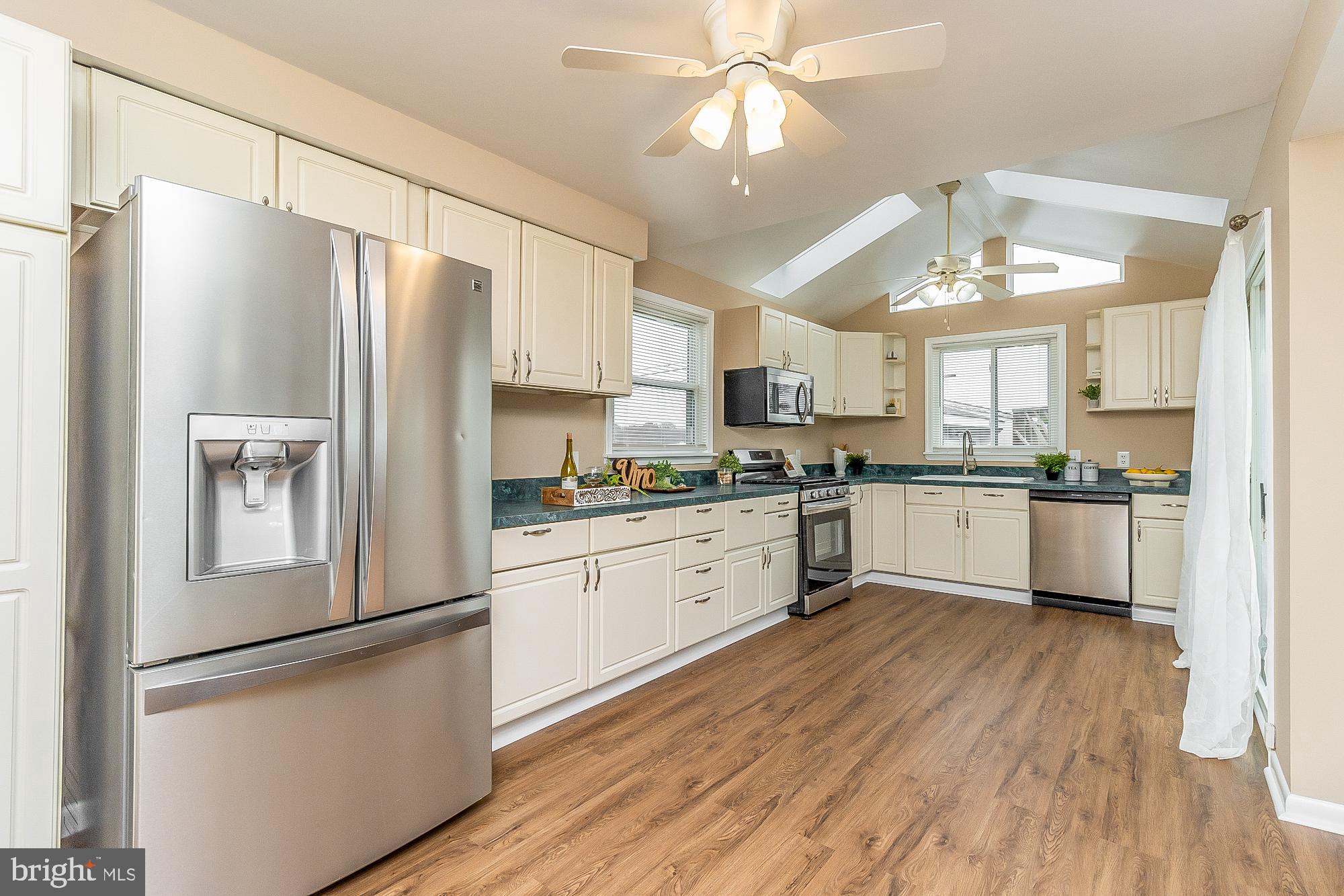 7501 Kenlea Avenue Nottingham, MD 21236 - Photo 22 of 55 a kitchen with stainless steel appliances a refrigerator sink and cabinets