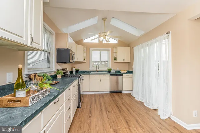 a view of a kitchen with stove and wooden floor