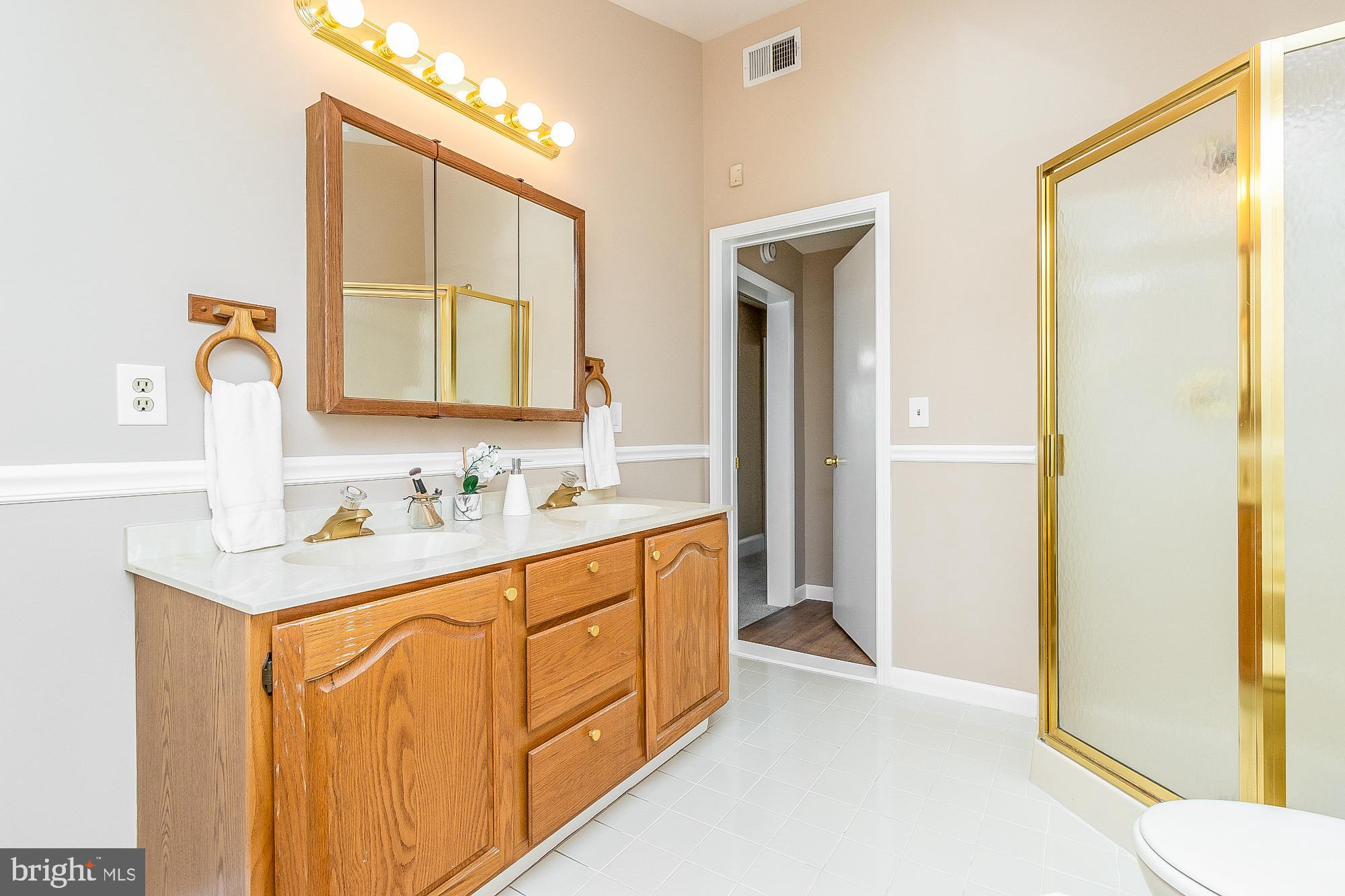 7501 Kenlea Avenue Nottingham, MD 21236 - Photo 39 of 55 a bathroom with a sink a mirror and a shower