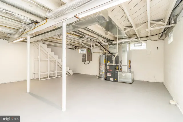 a view of a house with sitting area and wooden bench