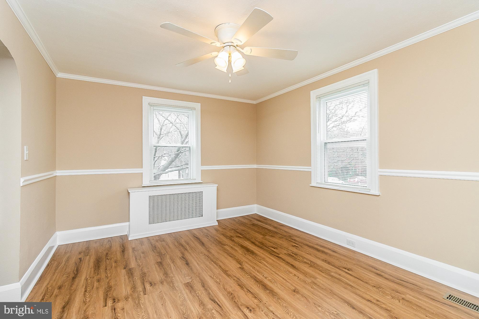 7501 Kenlea Avenue Nottingham, MD 21236 - Photo 10 of 55 a view of an empty room with wooden floor and a window