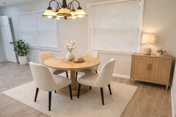 a dining room with furniture and wooden floor