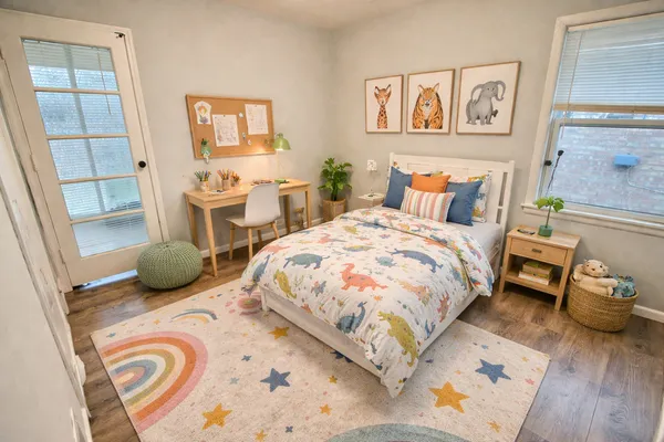 a bedroom with a bed a couch and a window