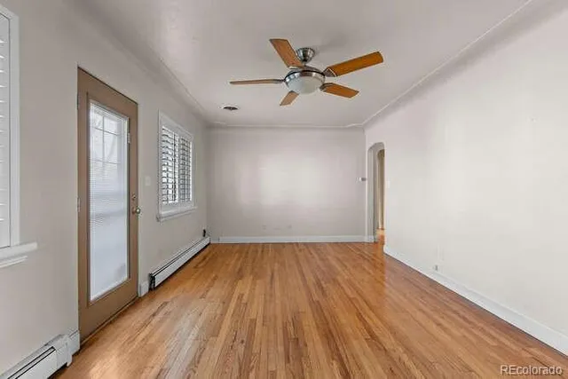 wooden floor in an empty room with a window