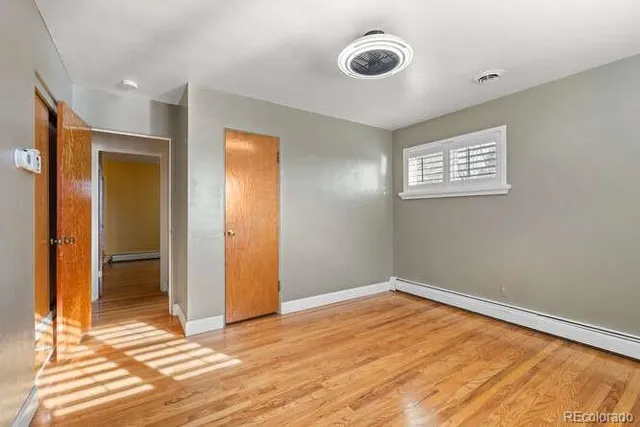a view of a room with wooden floor and bathroom