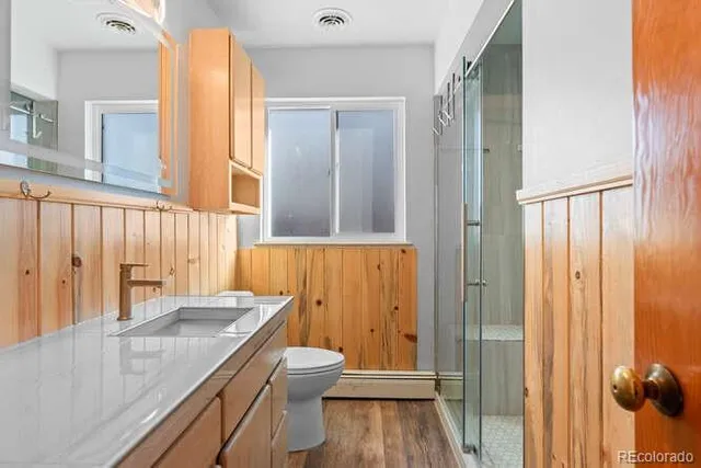 a bathroom with a granite countertop sink and a mirror