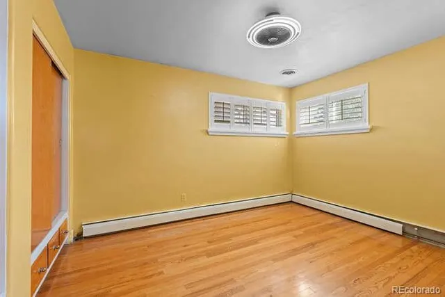 a view of a room with wooden floor and bathroom