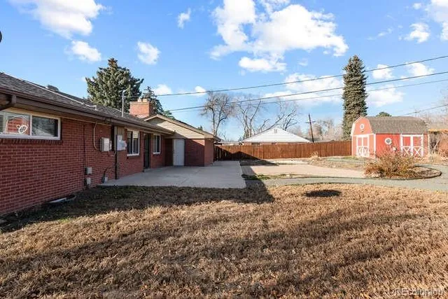 a backyard of a house with a yard and outdoor seating