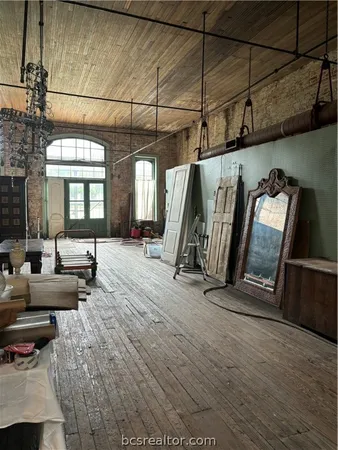 a view of a hallway with couch and chandelier