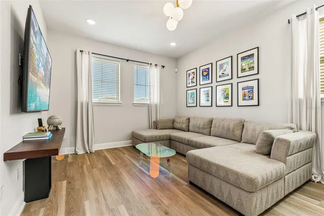 a living room with furniture and a painting on the wall