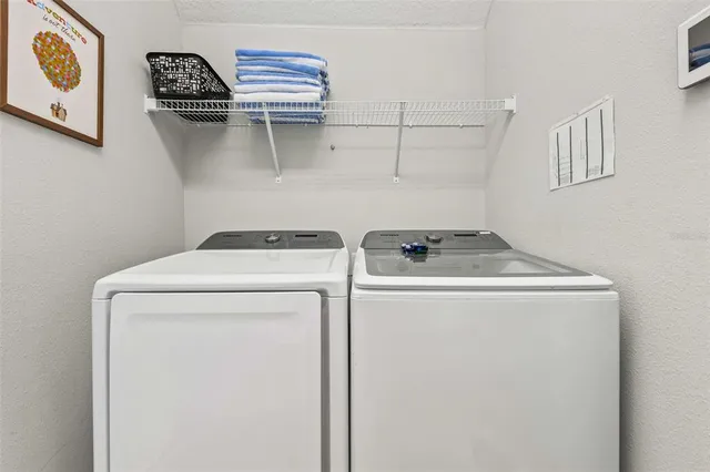 a bathroom with a granite countertop toilet sink and mirror