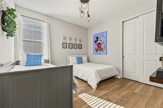 a bedroom with a bed and a chandelier