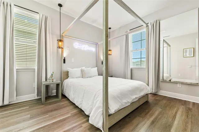 a bedroom with a bed and a painting on the wall