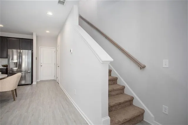 a view of entryway and hall with wooden floor