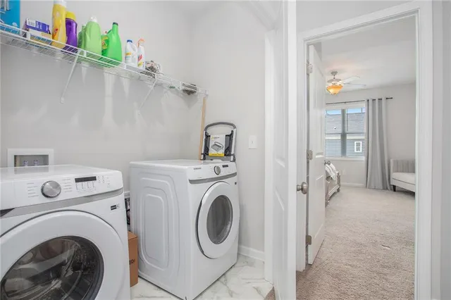 a view of a hallway with washer and dryer