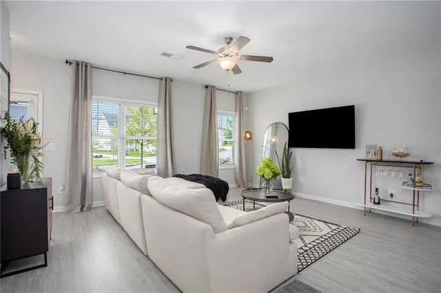 a living room with furniture and a flat screen tv