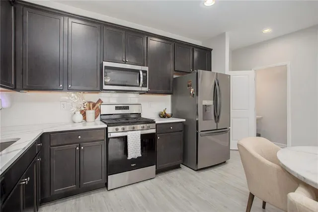 a kitchen with a refrigerator sink and microwave