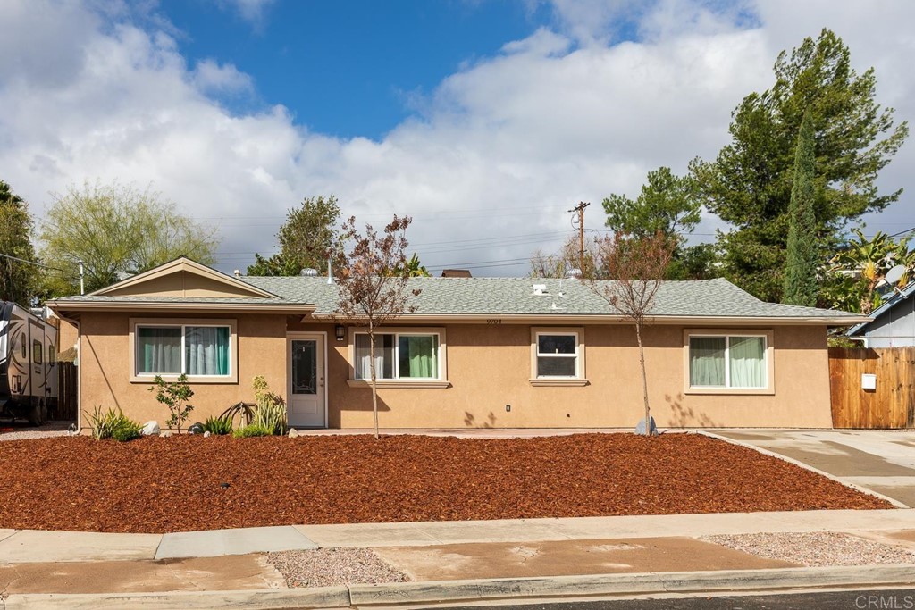 9704 Vomac Road Santee, CA 92071 - Photo 1 of 1 a front view of a house with a yard and garage