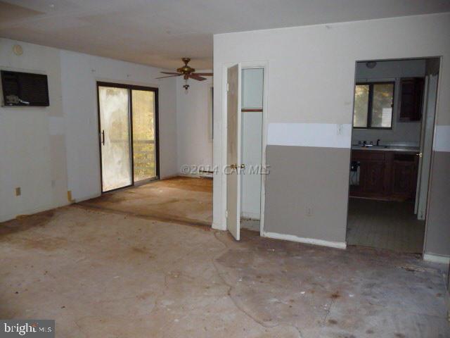 213 Windjammer Road Berlin, MD 21811 - Photo 4 of 10 an empty room with windows and cabinet