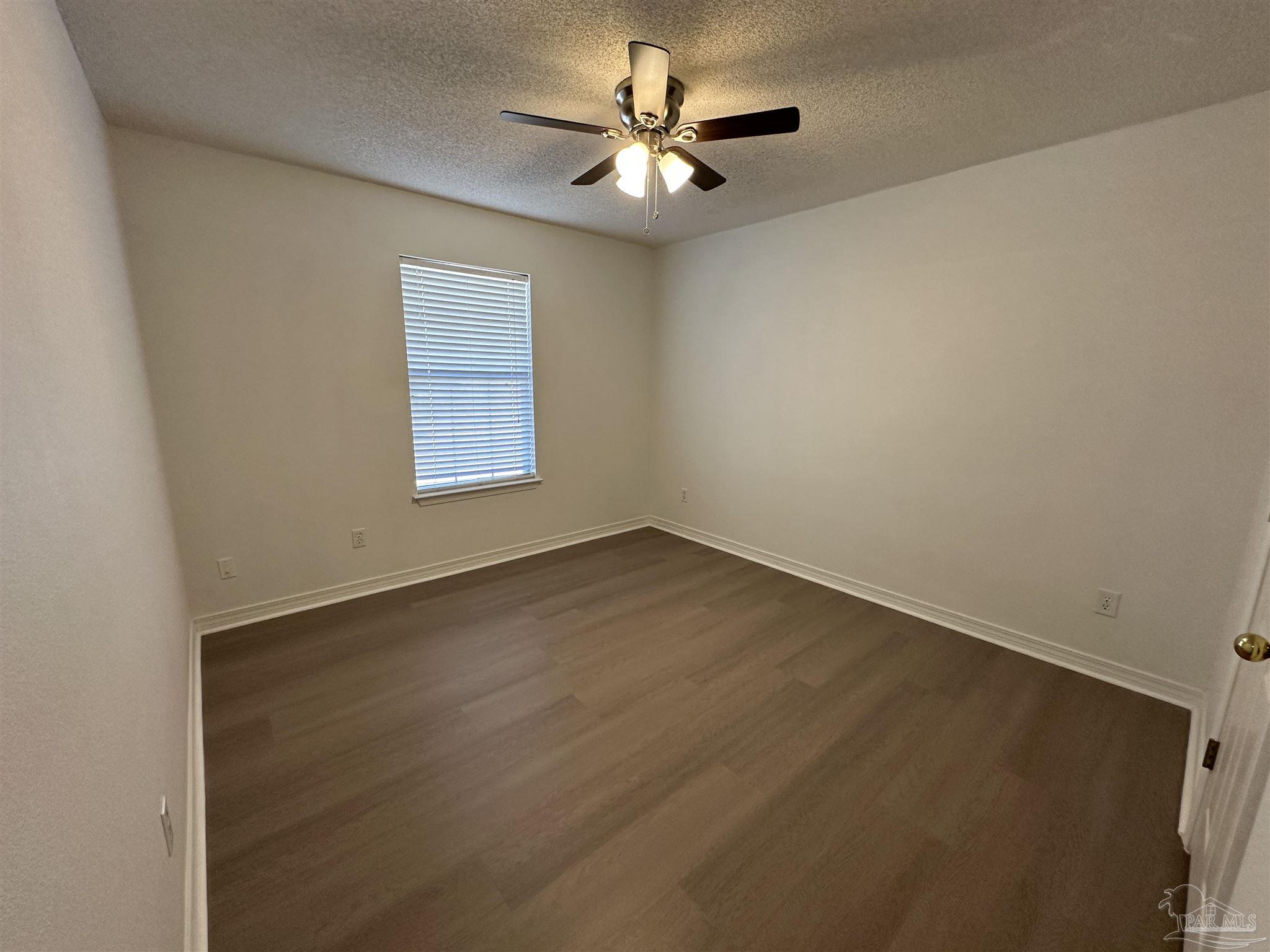 7959 Cayenne Way Pensacola, FL 32526 - Photo 13 of 19 an empty room with a window and a ceiling fan