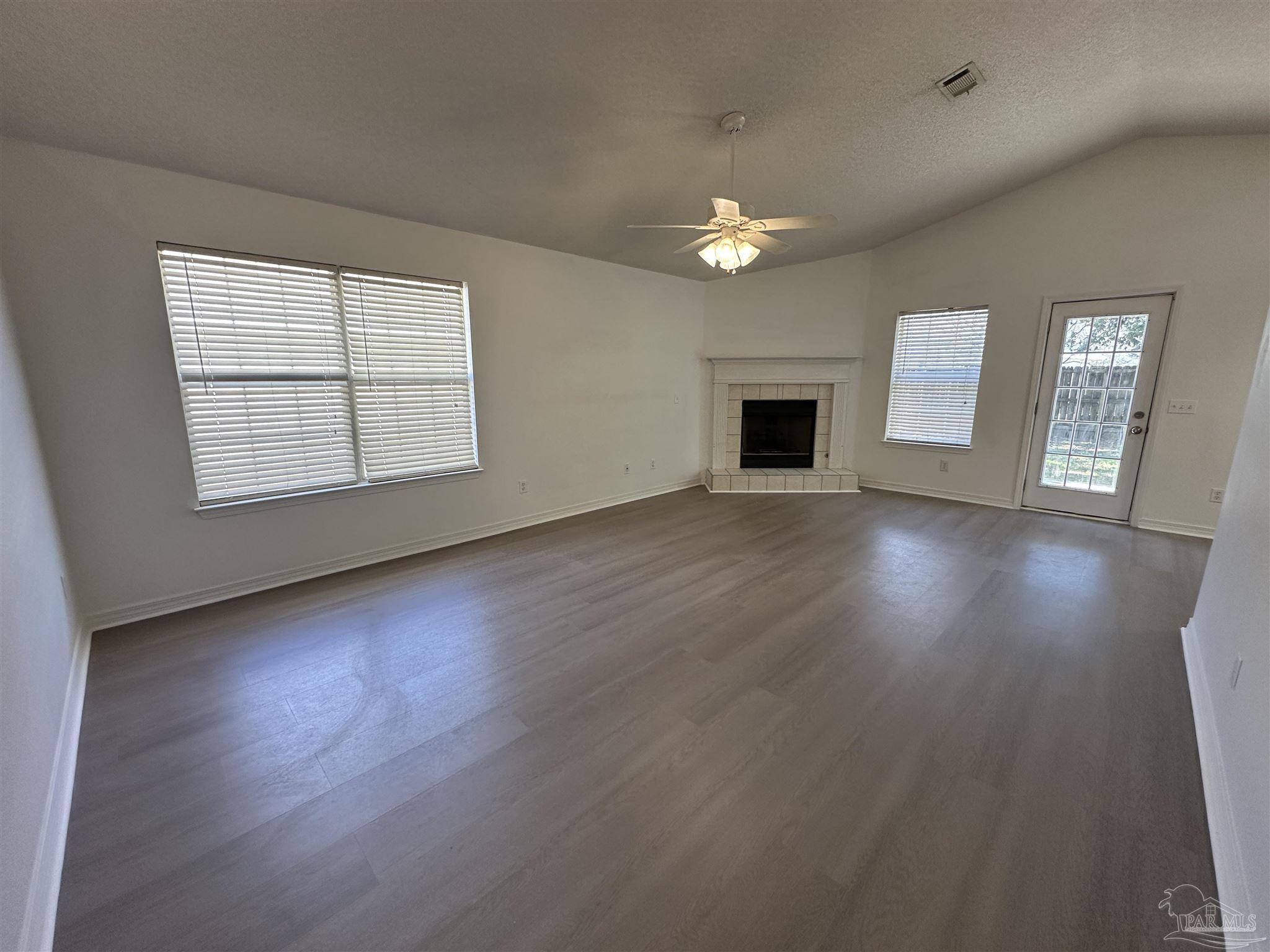 7959 Cayenne Way Pensacola, FL 32526 - Photo 2 of 19 an empty room with wooden floor and windows