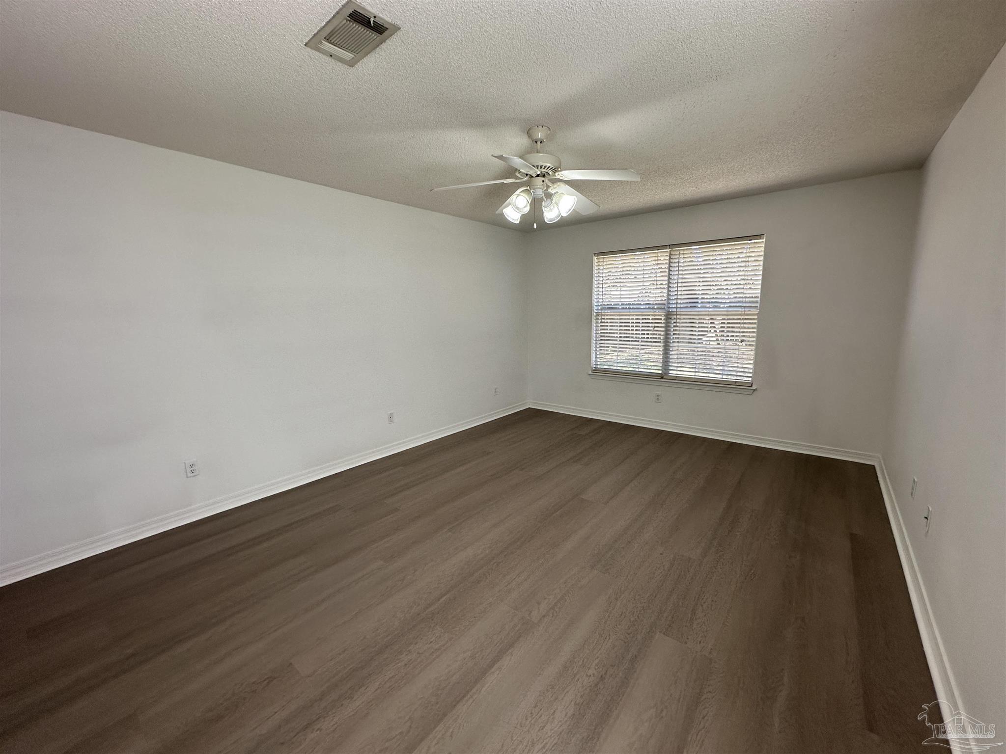 7959 Cayenne Way Pensacola, FL 32526 - Photo 8 of 19 an empty room with wooden floor ceiling fan and windows