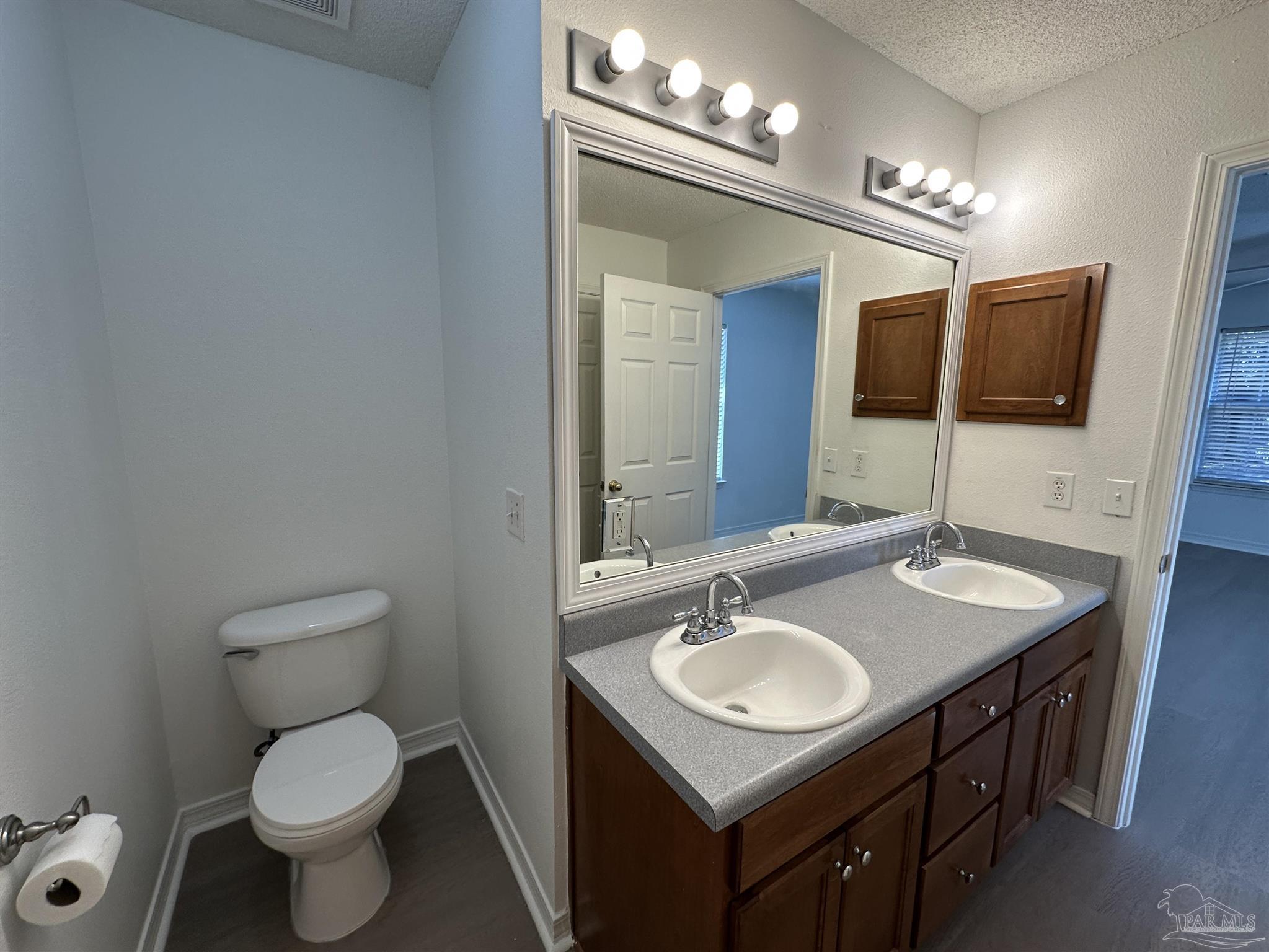 7959 Cayenne Way Pensacola, FL 32526 - Photo 10 of 19 a bathroom with a toilet a sink and a mirror