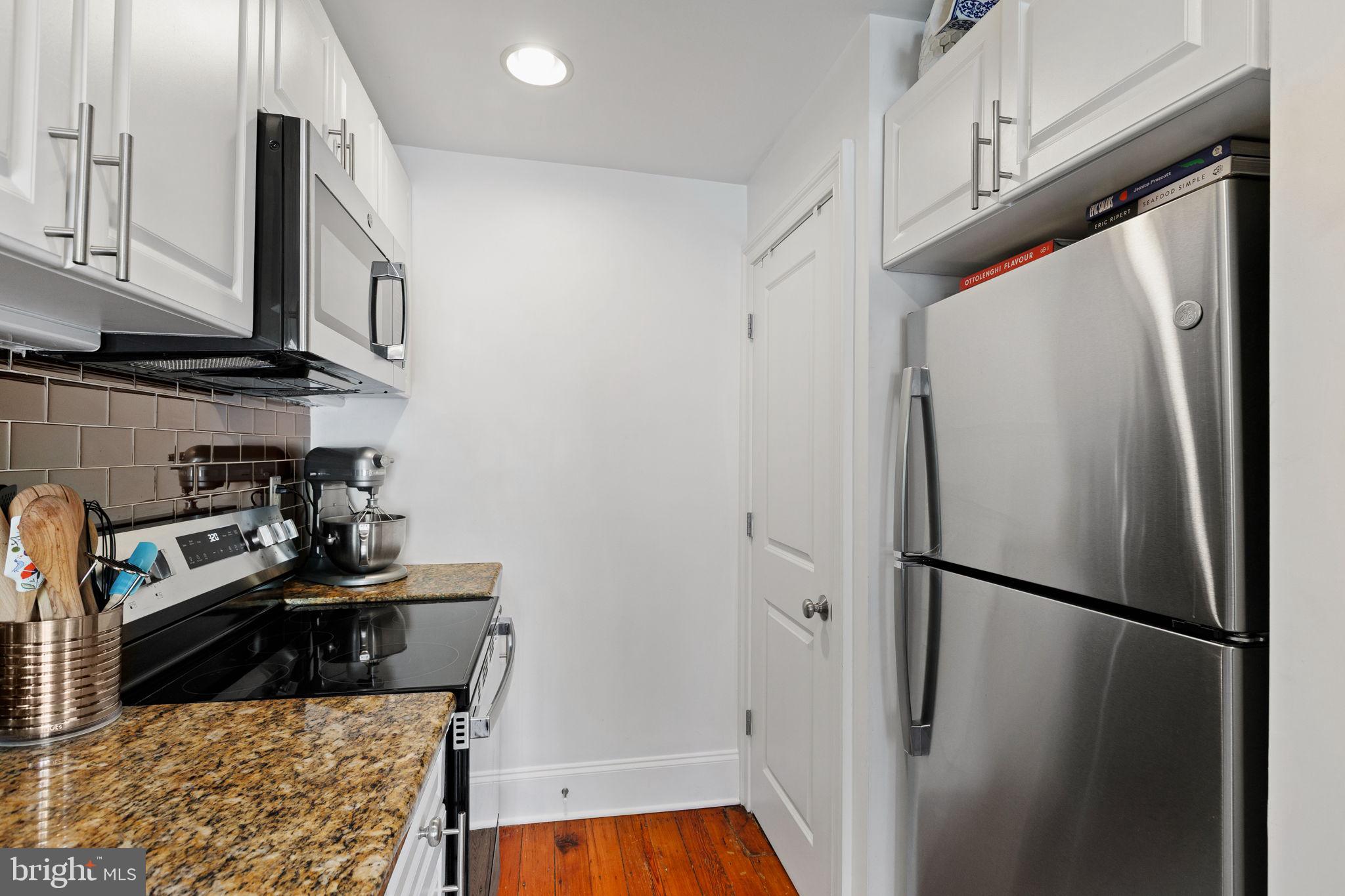 1708 Pine Street, Unit 4F Philadelphia, PA 19103 - Photo 7 of 16 a kitchen with a refrigerator a stove and a microwave
