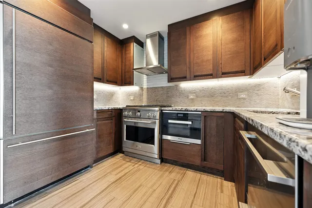 a kitchen with granite countertop a stove and a sink