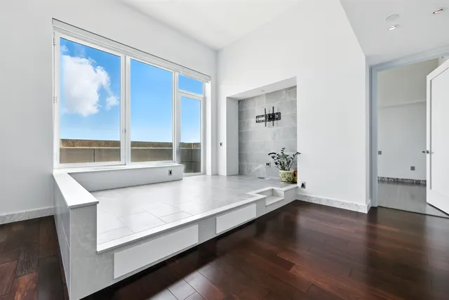 a living room with hard wood floors and a window