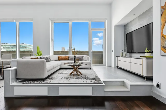 a living room with furniture and large flat screen tv