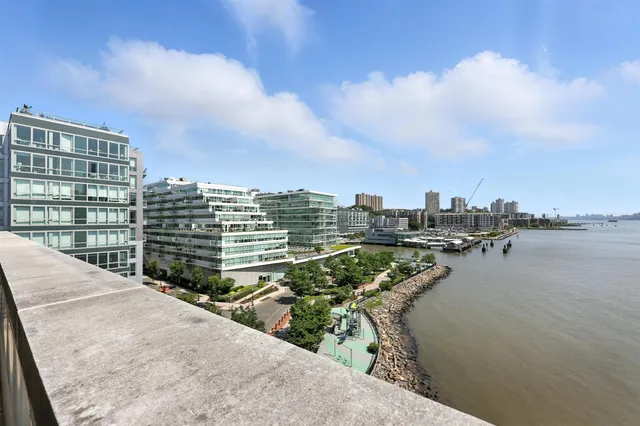 a view of an empty room with wooden floor and closet
