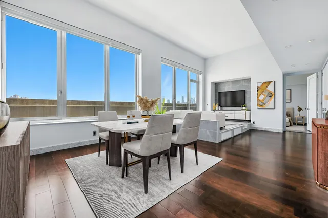 a view of a dining room with furniture window and wooden floor