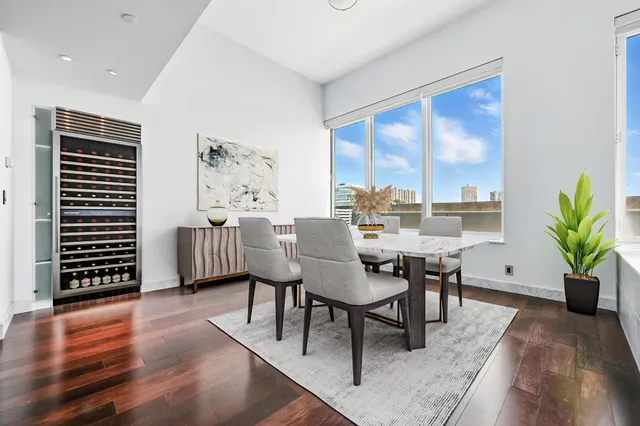 a view of a dining room with furniture window and wooden floor