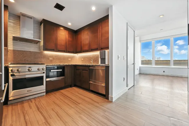 a kitchen with stainless steel appliances granite countertop a stove and a refrigerator