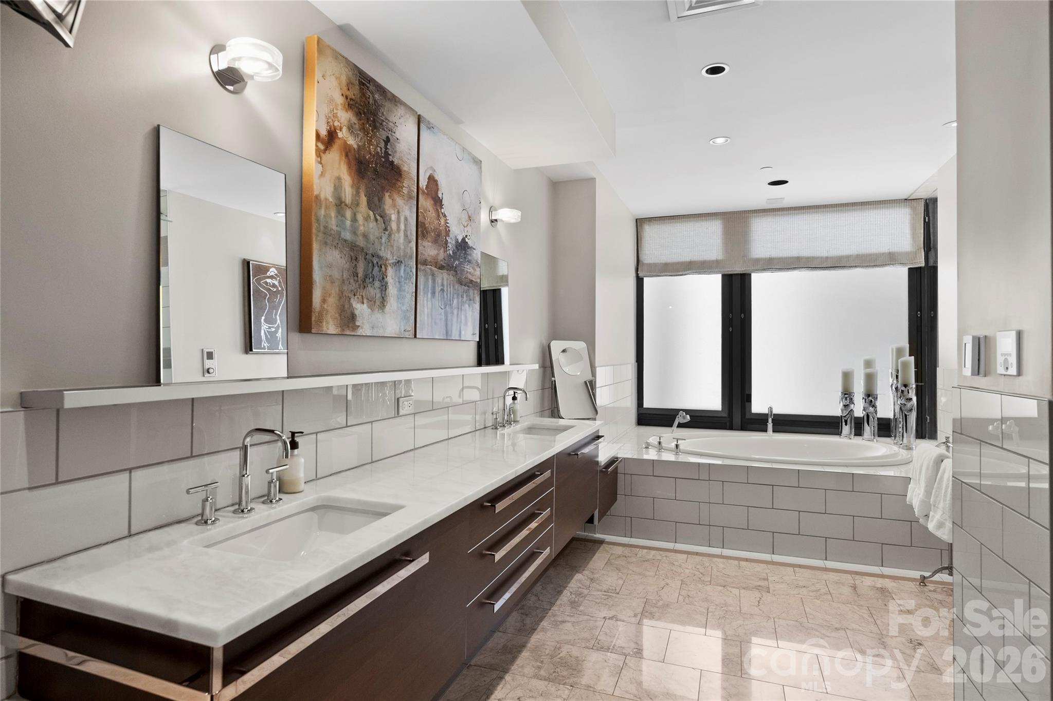 139 South Tryon Street, Unit 6 Charlotte, NC 28202 - Photo 34 of 47 a bathroom with a sink and a bathtub