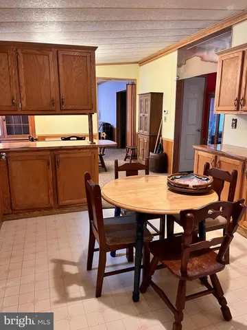 a dining room with a wooden table and chairs