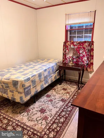 a bedroom with a bed and a rug