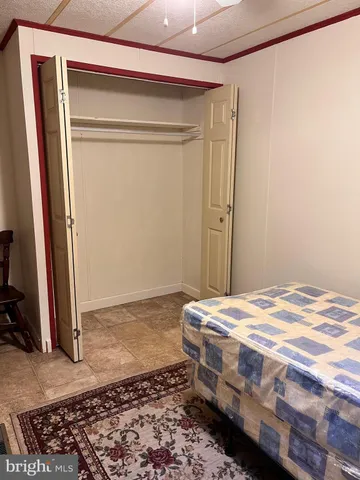 a living room with a bed furniture and a large window