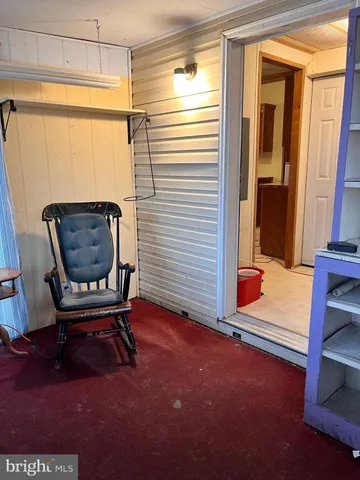 a room with wooden floor and windows