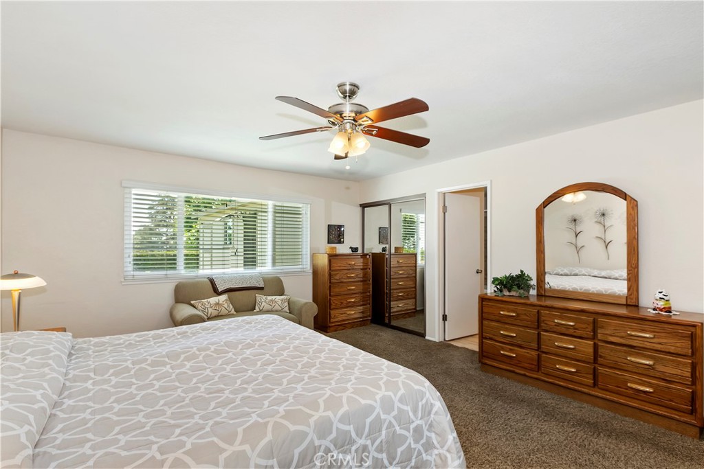 8527 Hillside Road Rancho Cucamonga, CA 91701 - Photo 27 of 50 a bedroom with a bed and a dresser with mirror