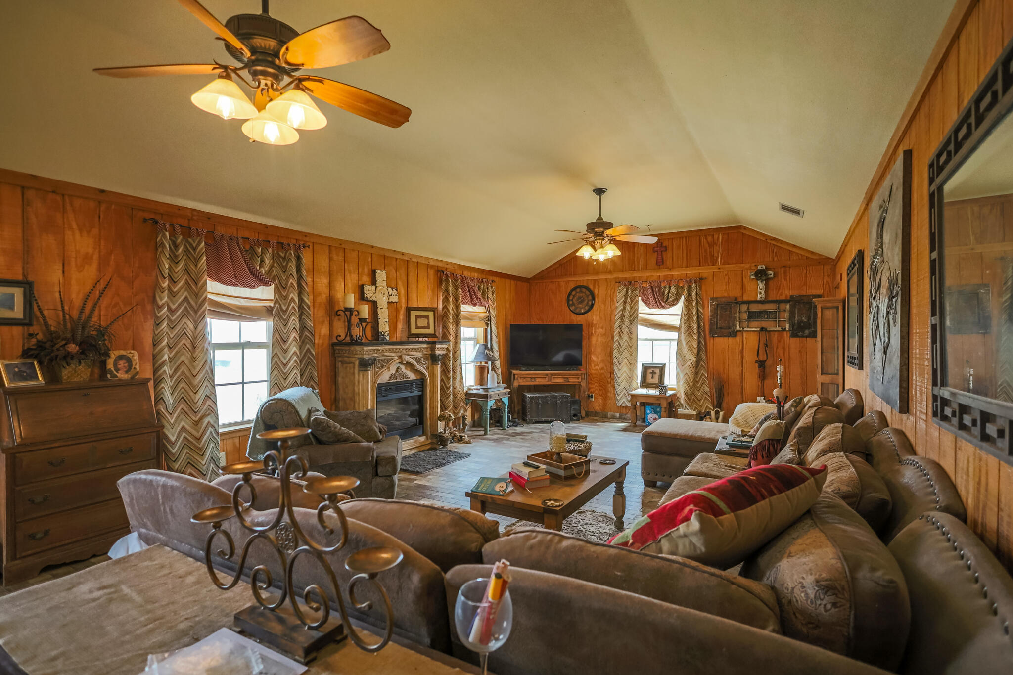 3401 East Regis Street Lubbock, TX 79403 - Photo 11 of 65 a living room with furniture a chandelier and a flat screen tv