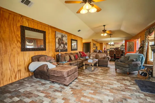 a view of a dining room with furniture and chandelier