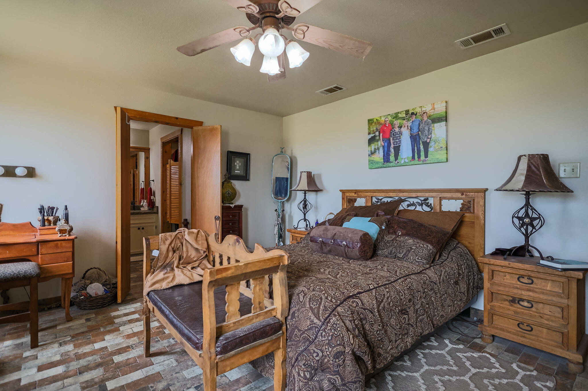 3401 East Regis Street Lubbock, TX 79403 - Photo 19 of 65 a bedroom with a bed and wooden floor