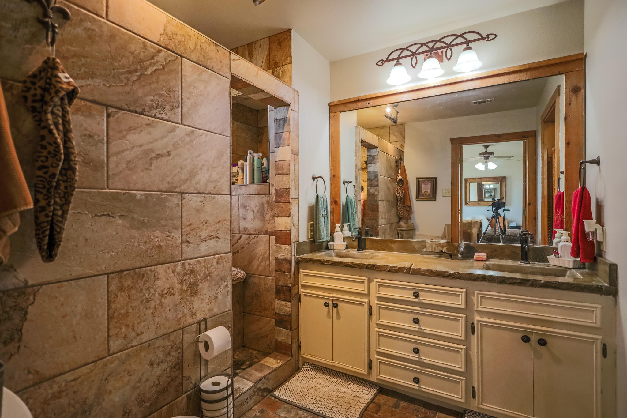 3401 East Regis Street Lubbock, TX 79403 - Photo 21 of 65 a bathroom with a sink and a mirror