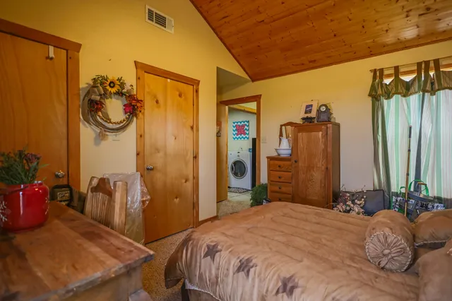 a bedroom with bed and a chandelier