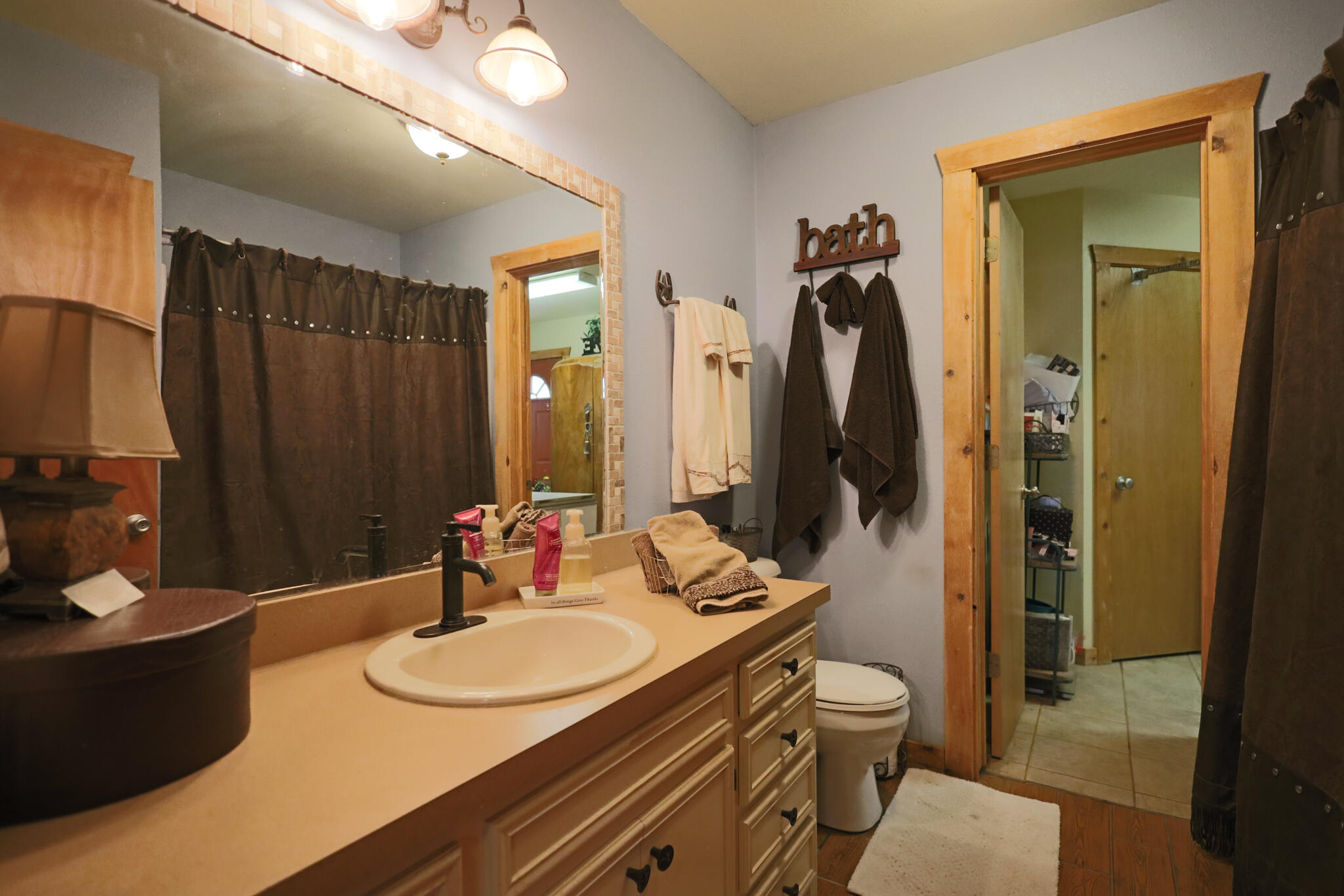 3401 East Regis Street Lubbock, TX 79403 - Photo 26 of 65 a bathroom with a double vanity sink toilet and shower