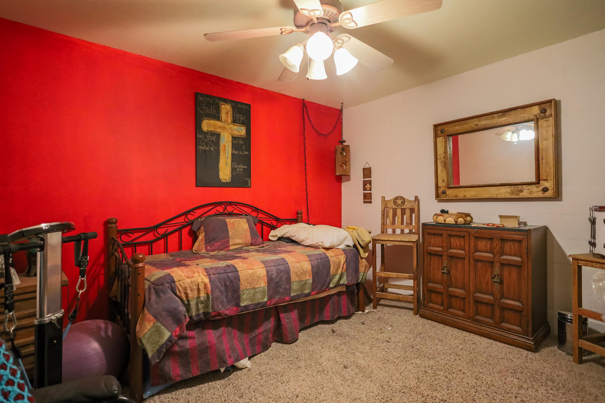 3401 East Regis Street Lubbock, TX 79403 - Photo 28 of 65 a bedroom with bed and a chandelier