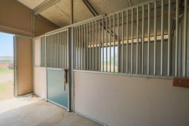 a view of swimming pool with lawn chairs and iron fence